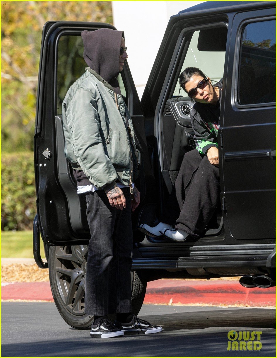 Kourtney Kardashian & Travis Barker Share Steamy Kiss Arriving at