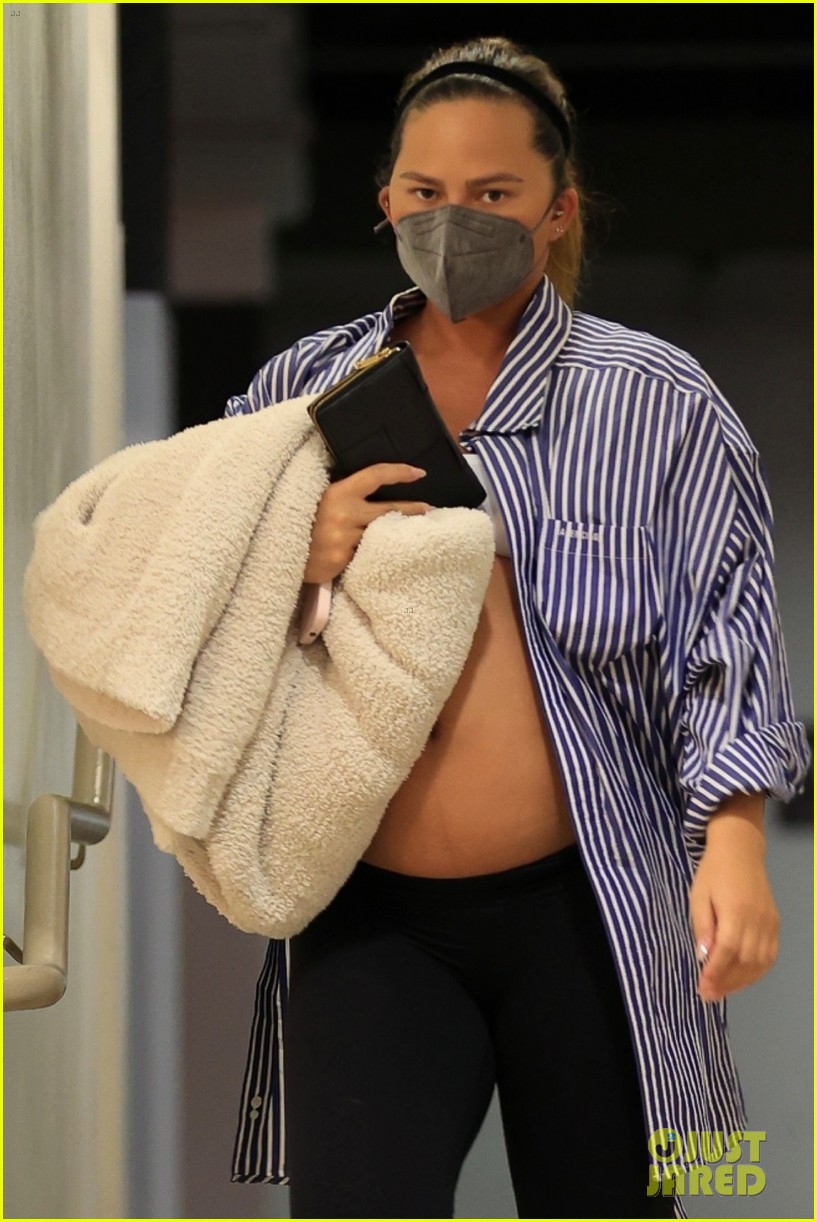 Chrissy Teigen Bares Large Baby Bump While Wearing an Unbuttoned Shirt