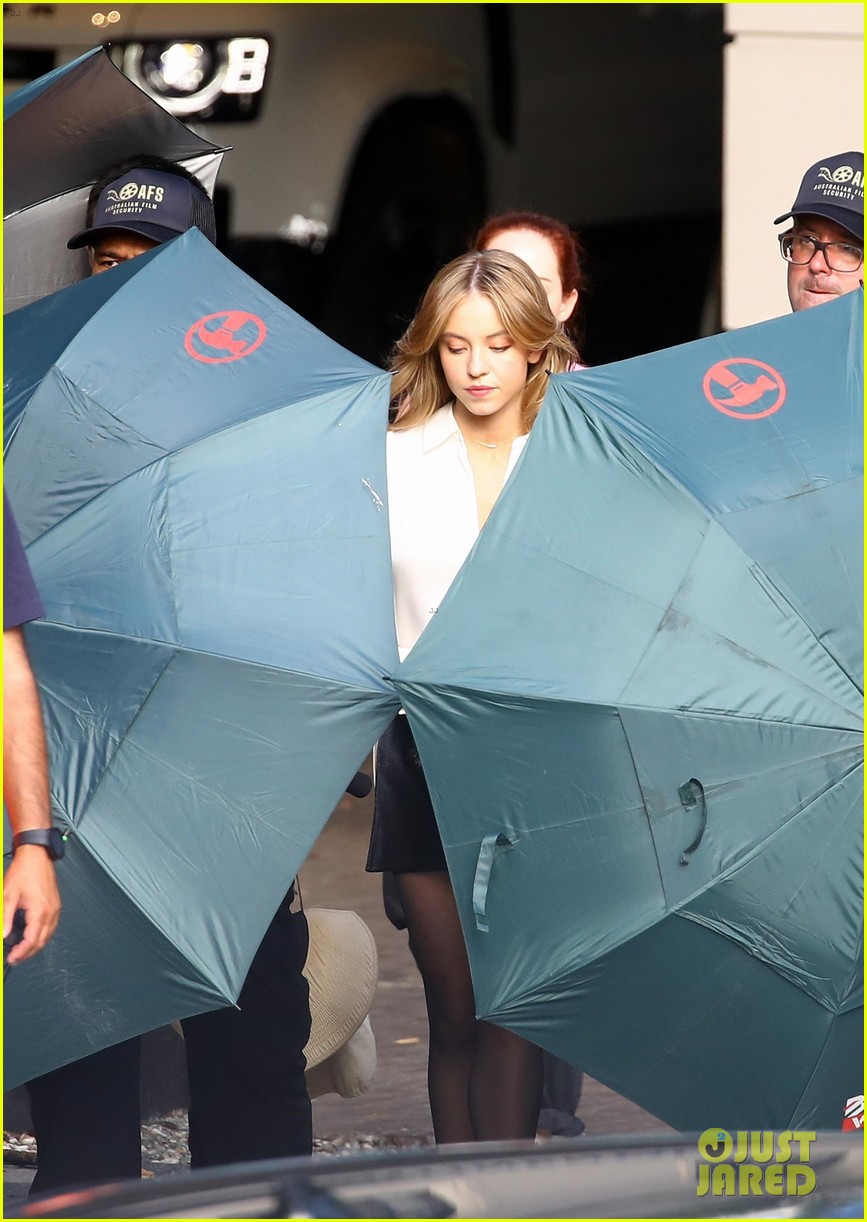 Sydney Sweeney Gets Covered By Giant Umbrellas While Shooting Top