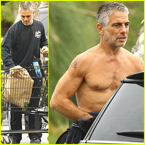 A shirtless Tony Danza pulls on a long sleeved tee as he leaves his car and...