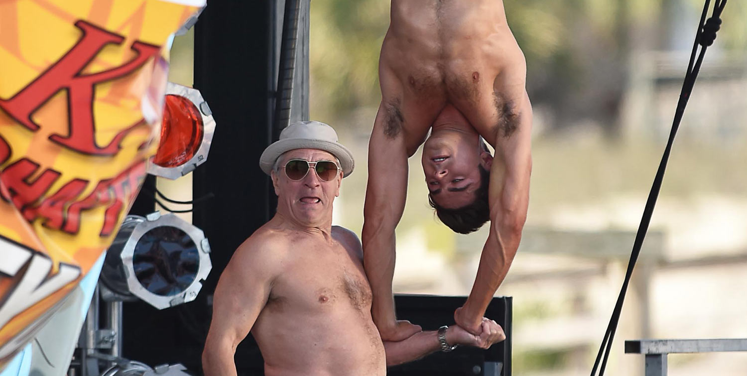 Zac Efron does a balancing act on his co-star Robert De Niro while going sh...
