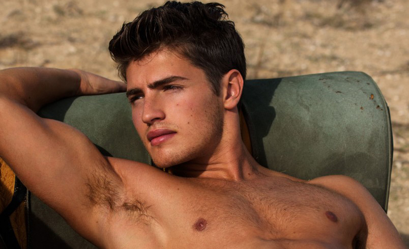 Gregg Sulkin poses shirtless in the desert while wearing just a pair of und...