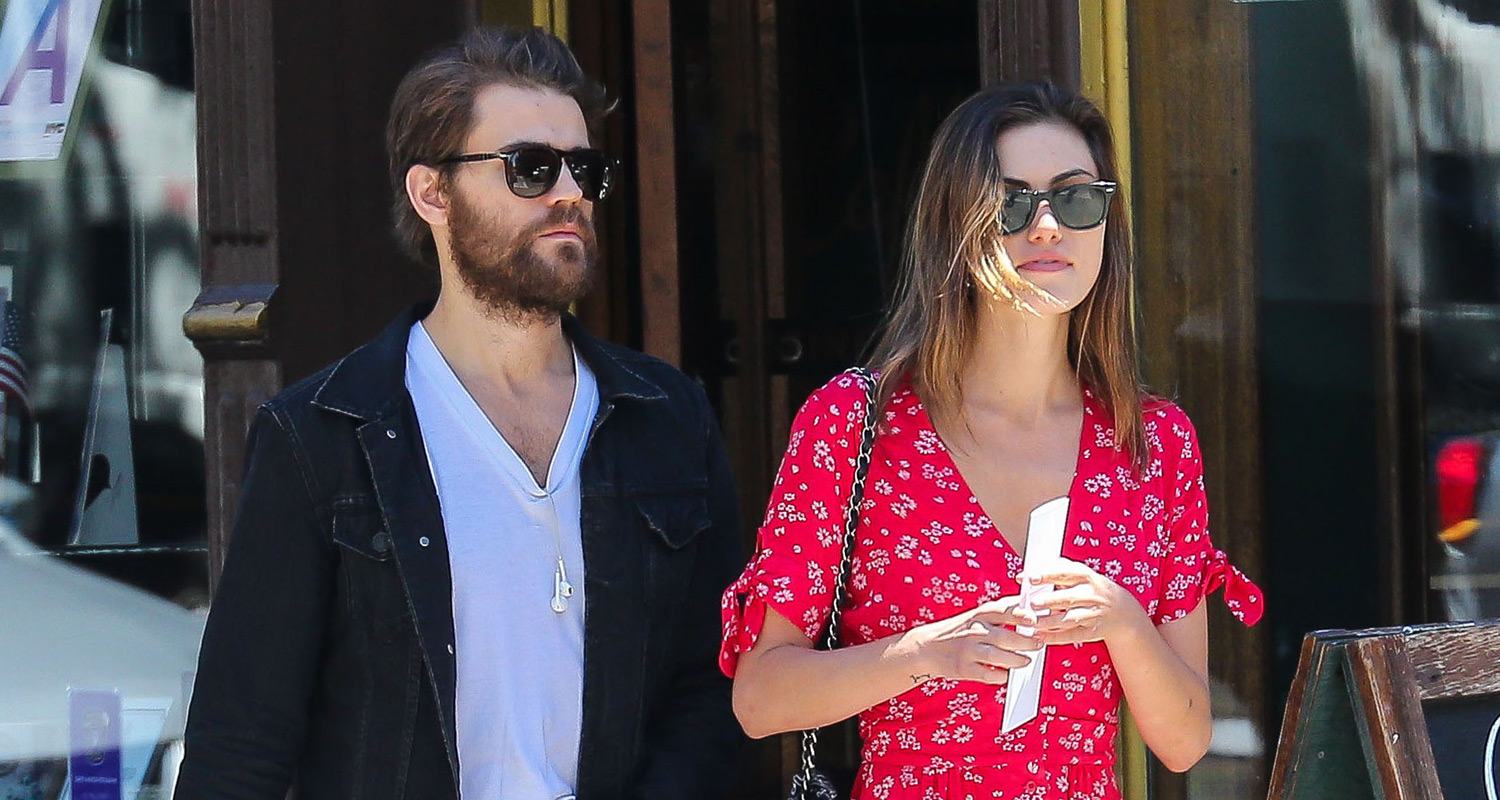 Paul Wesley and his girlfriend Phoebe Tonkin stick close together while hea...