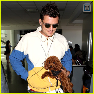 Orlando Bloom Carries His Cute Dog Through the Airport